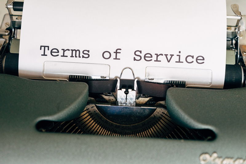 Illustration of legal documents and scales of justice, representing terms and conditions
