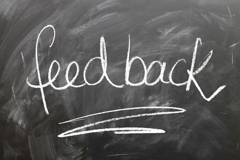Chalkboard with 'Feedback' written, representing customer communication and returns policy